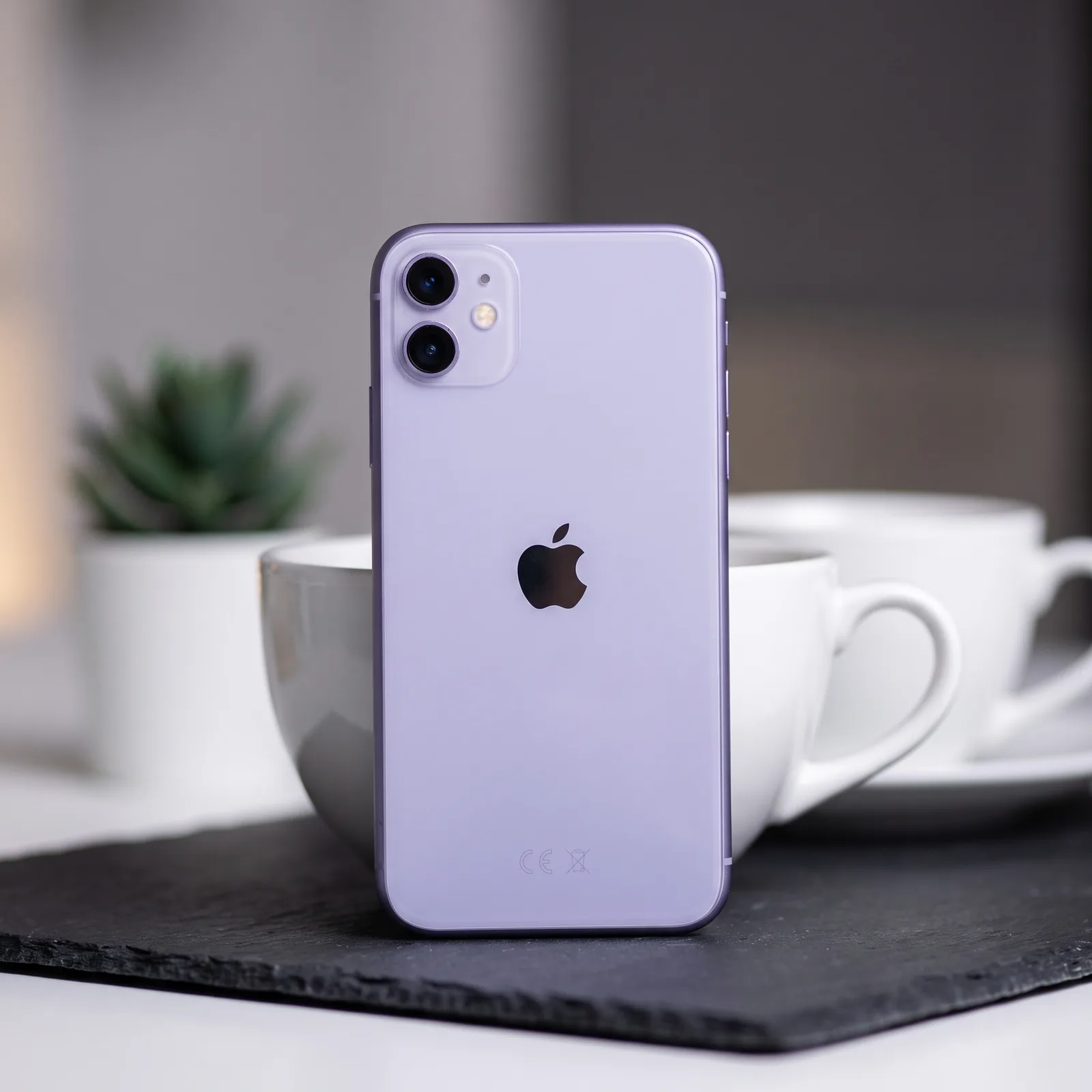 Lifestyle image of a refurbished iPhone 11 in Purple being held, highlighting its colour and premium design by MTM IT.
